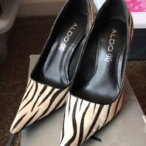 Woman’s pointy toe zebra print pumps.